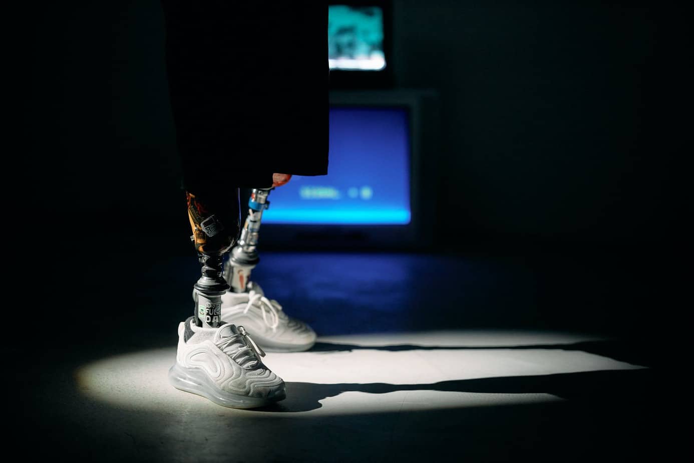 photo of white sneakers on spotlight