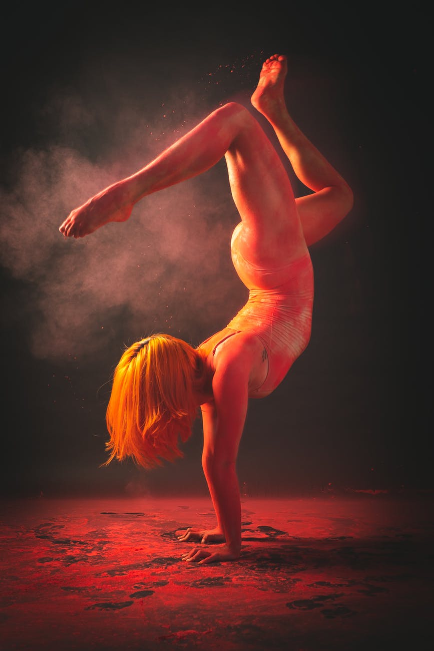 a woman doing hand stand