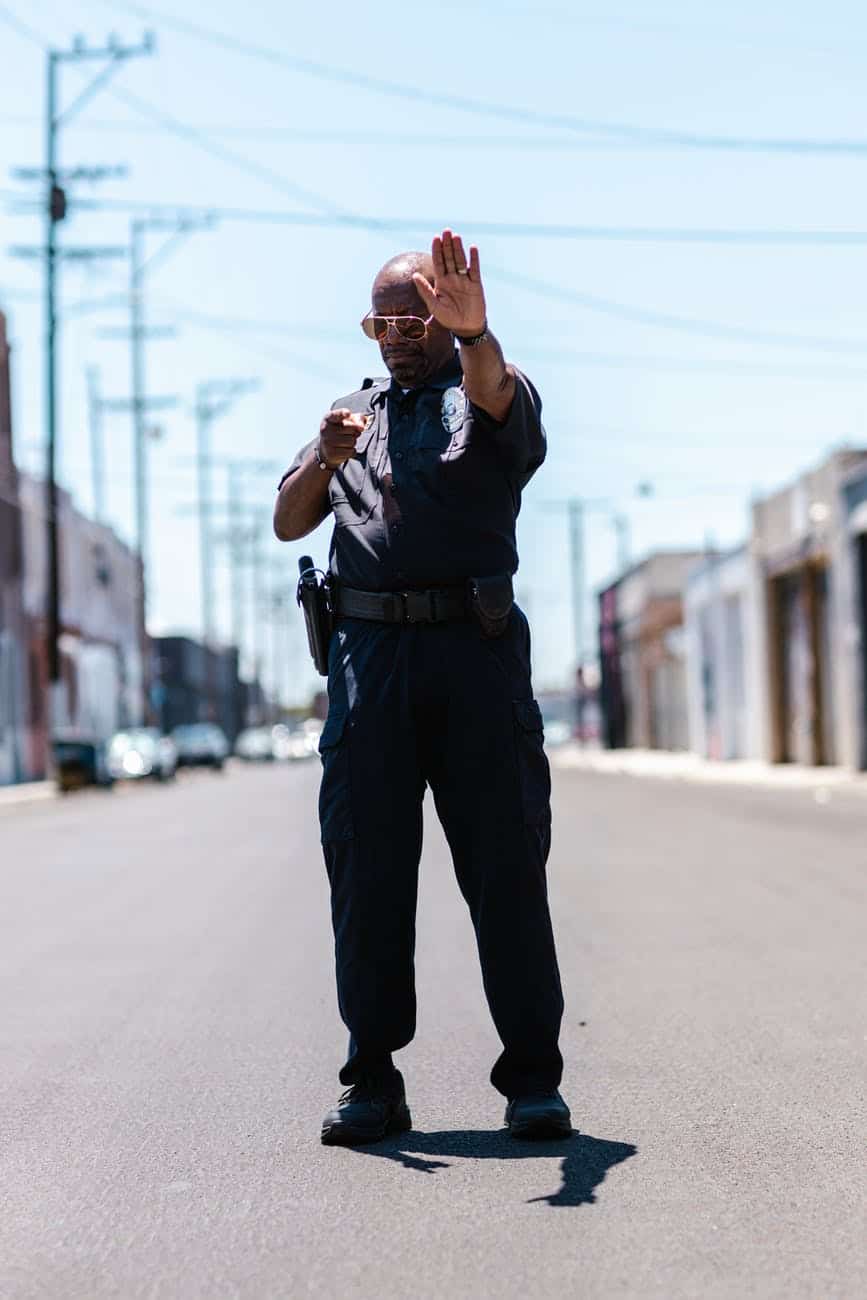 photo of a police gesturing to stop